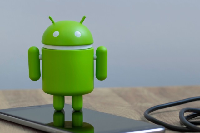 Android figure on smartphone