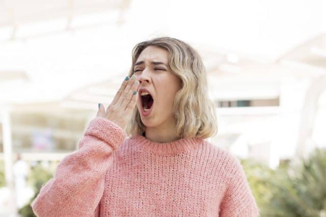 Bored woman yawning